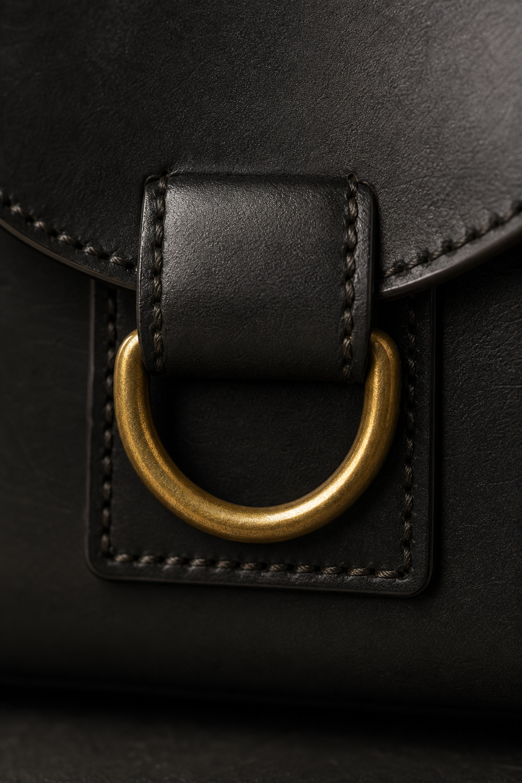 Cast D-ring closure on the Brazen Vault Crossbody, macro detail. Interim render — pending real photography.